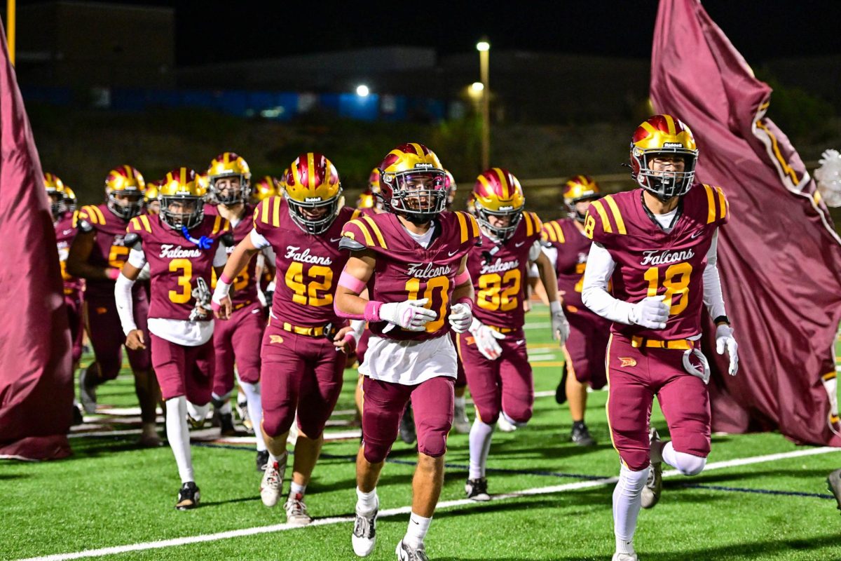 The varsity football team makes its way onto the field after winning against Poway High School 40-22. This was the team's fourth win of the season. Photo courtesy of Anna Scipione.