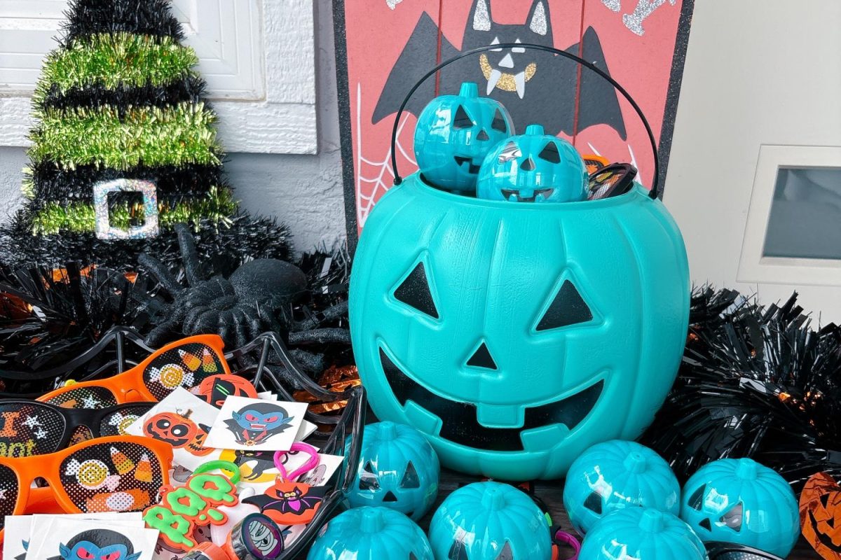 A house displays an arrangement of teal pumpkins on its front porch.The pumpkin was surrounded by non-food treats, already prepared for trick-or-treaters on Halloween.