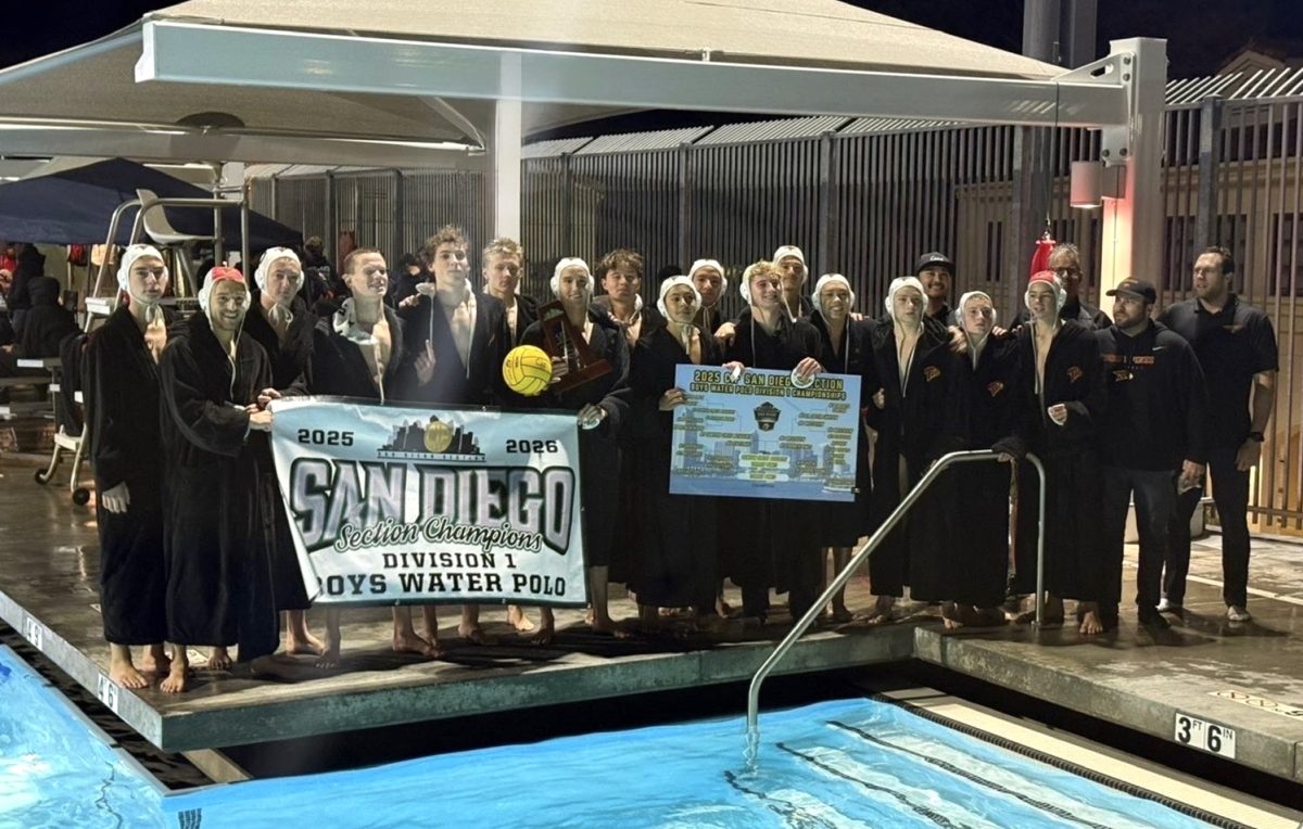 The varsity water polo team holds up their Division I CIF banner after their victory against Canyon Crest Academy. The team ended their season with a record of 17-12. Photo courtesy of Julian Breeze.