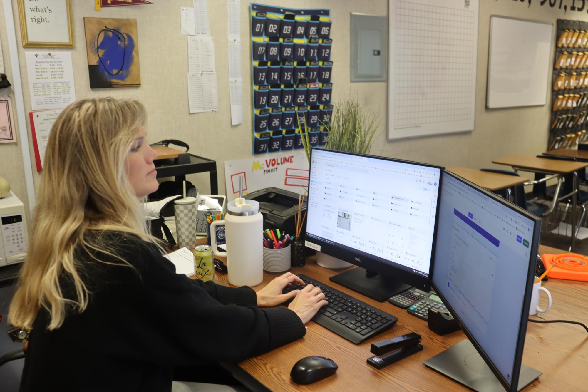 Katlin Hildebrand  types at her desk while students are working. She taught Advanced Placement Calculus AB and Personal Finance.