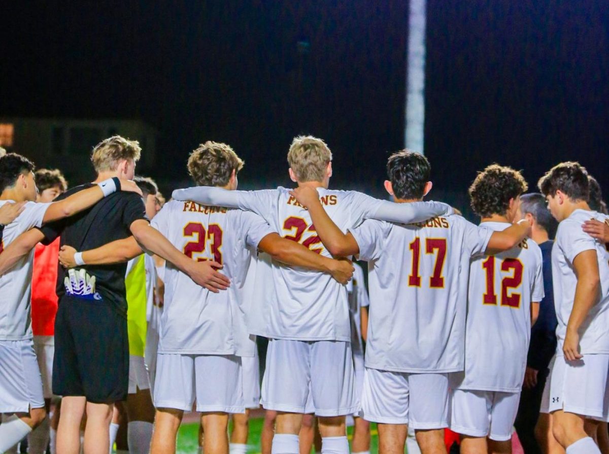 Before kickoff, the team gathers for their usual team ritual. Their coach gave a motivational talk and prayer, reinforcing the idea that the team needed unity. Photo courtesy of Dillon Vu.