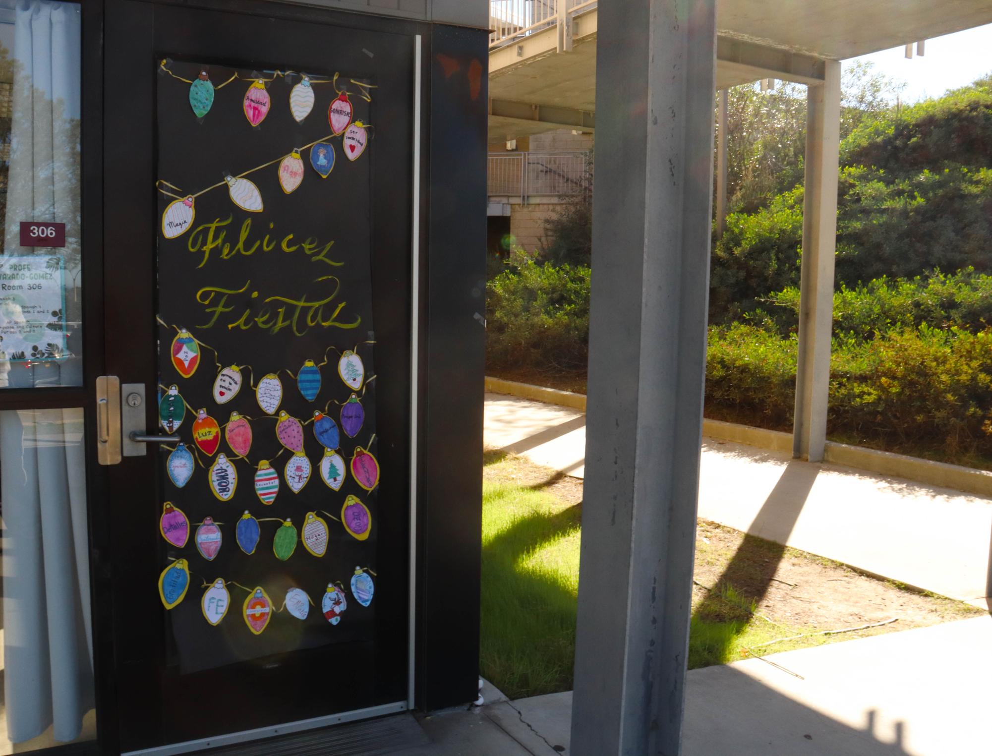 Spanish teacher Viviana Alvarado Gomez's door illuminates the language hallway with its vibrant paper lights colored by her first-period students. Alvarado Gomez had her students adorn the bulbs with holiday messages in Spanish.