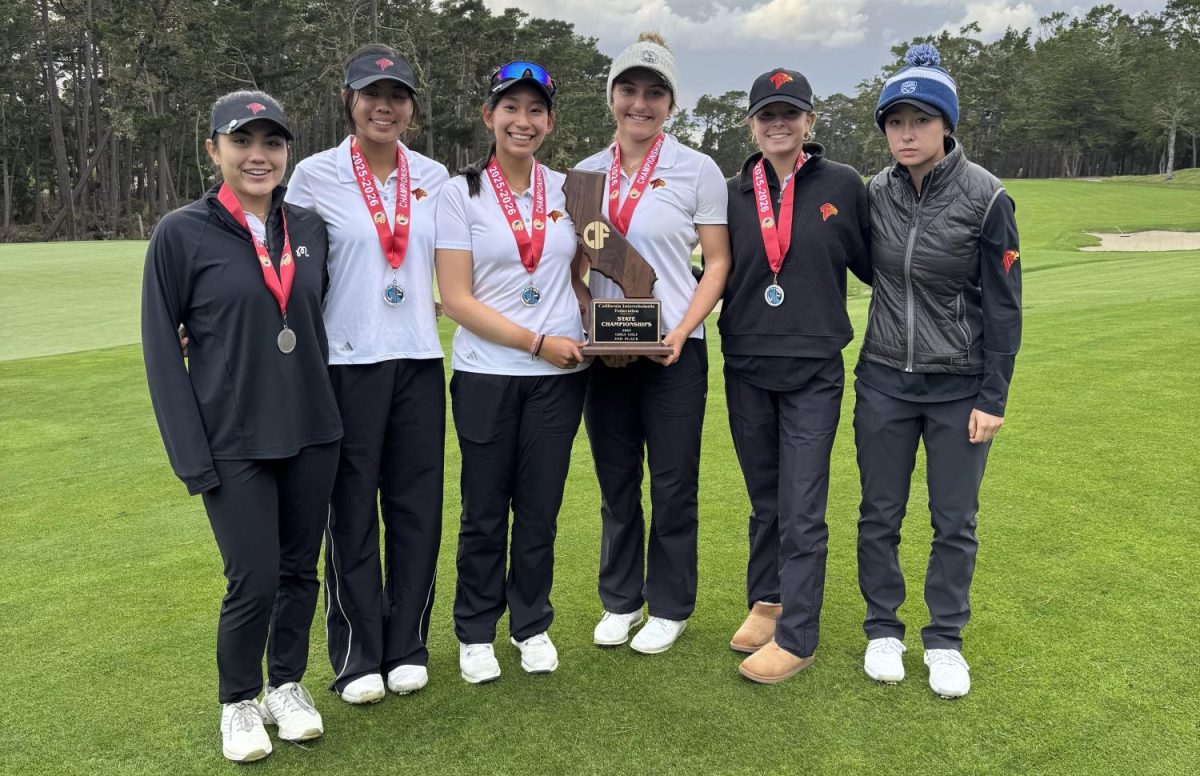Left to right: Tyanna Jacot (12), Kate Hu (11), Zoe Jiamanukoonkit (12), Alice Koontz (12), Olivia Richardson (10) and Sydney Kroc (10). The Cardinal girls golf team smiles as Koontz and Jiamanukoonkit hold up the second place trophy on the golf course. They placed second in the California Interscholastic Federation State Tournament at Poppy Hills Golf Course on Nov. 19. Photo courtesy of Jiamanukoonkit.