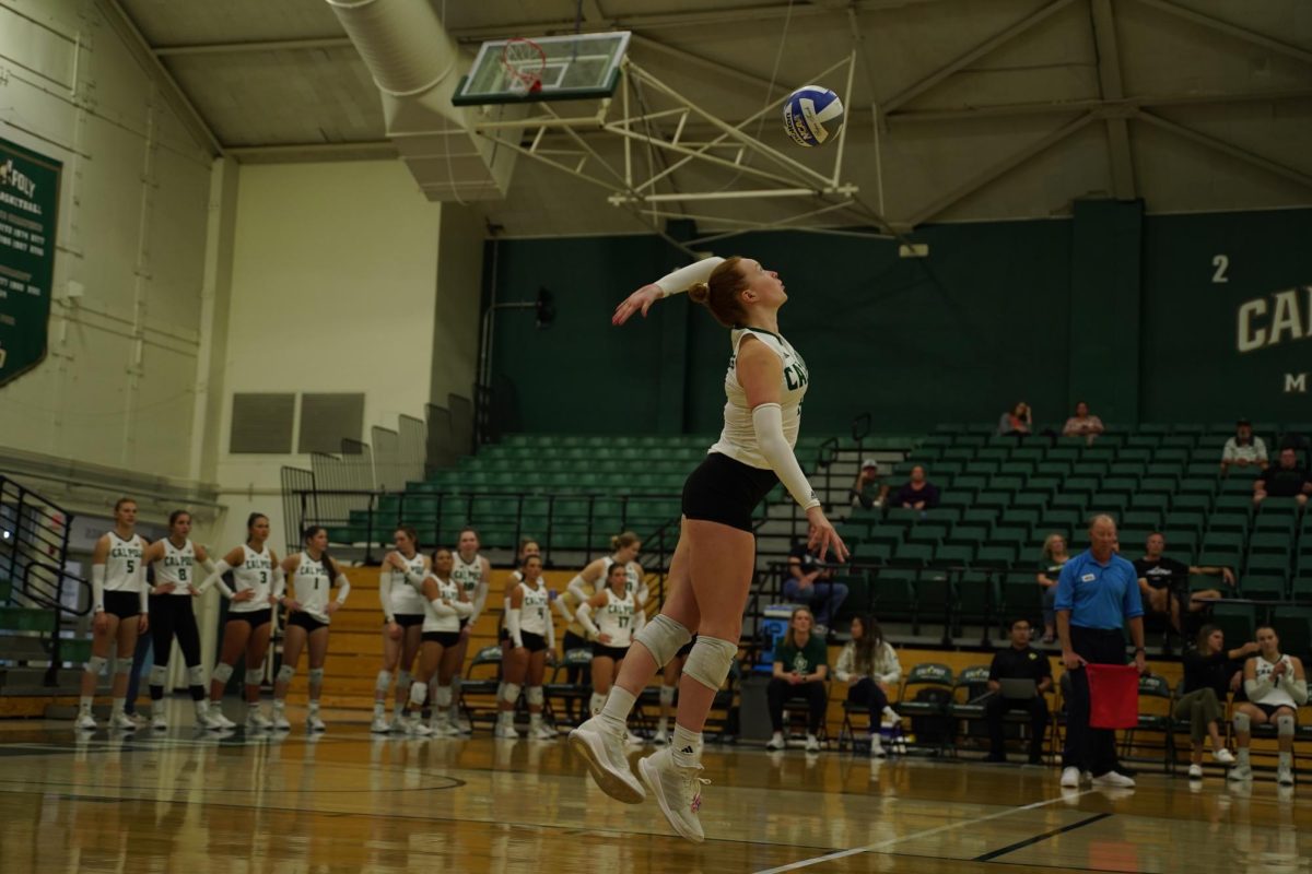 Brooklyn Burns ('22) serves a volleyball in California Polytechnic State University gymnasium. Burns committed to "SLO" before her senior year. Photo courtesy of Brooklyn Burns.