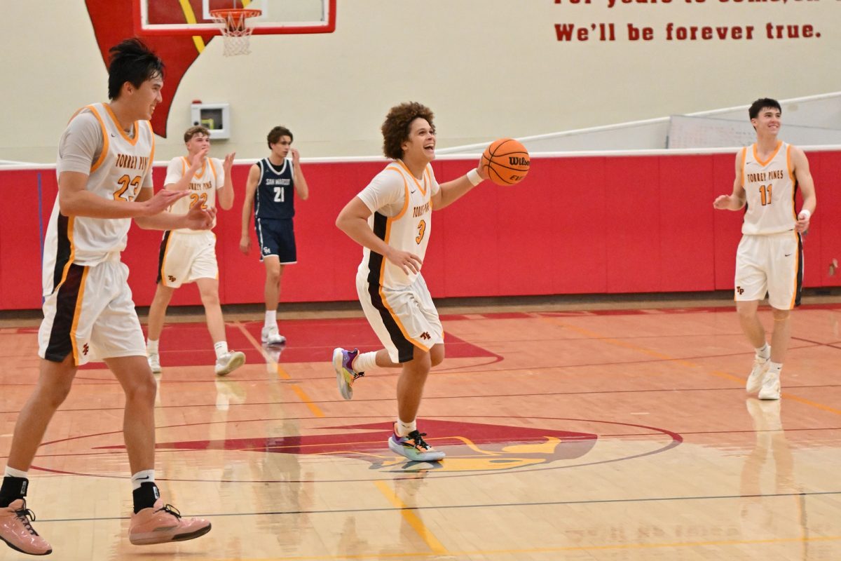Tevaris Green (12) brings the ball up the court during a varsity basketball game. A multi-year varsity player, Green has emerged as a key leader for the Falcons this season. Photo courtesy of Anna Scipione.
