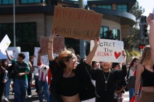 Jenny Velasquez (12) lifts her sign. It read: "I'm missing my lesson to teach you one."