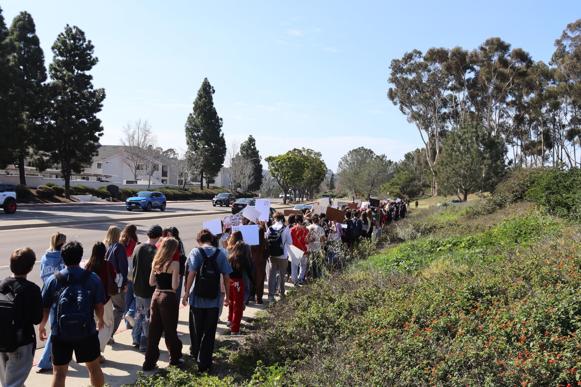 Torrey Pines High School protestors walk down Del Mar Heights Road on Feb 9. One of the organzers demands to revise SDUHSD Administrative Regulation (AR) 5145.13 was successful.