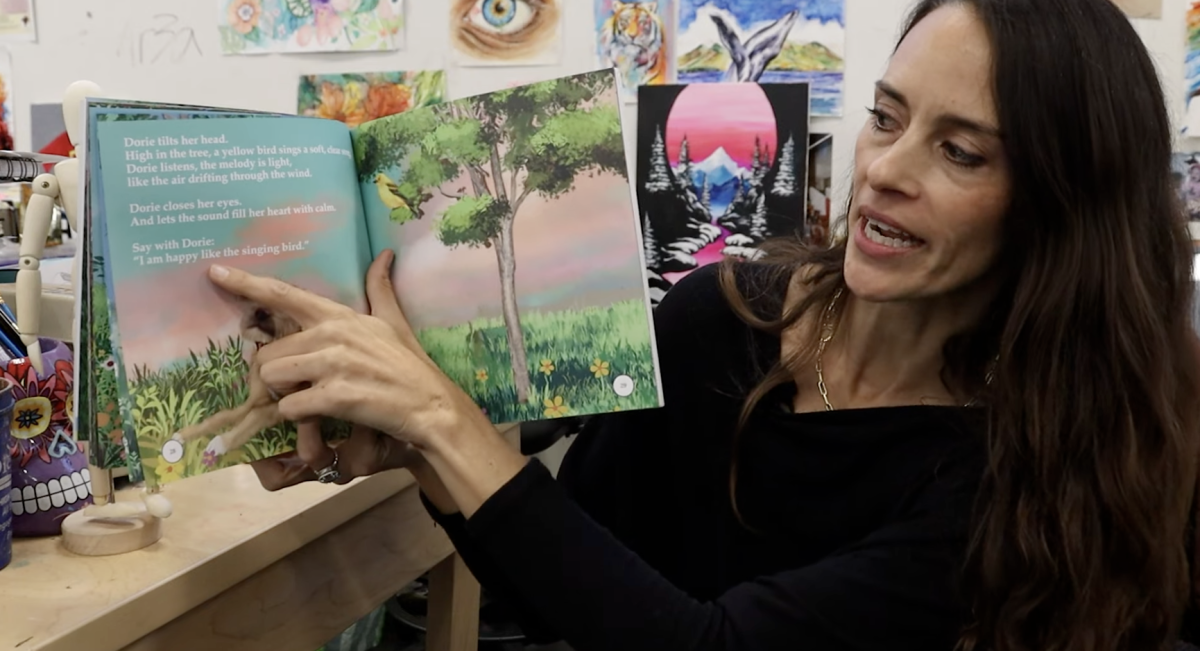 Art teacher Katie O'Brien reads her book. O'Brien published her book in January. Photo courtesy of Eamon Hinton. 