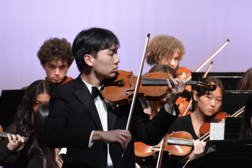 Anthony Kim (12) prepares to play his violin during a concert. Kim chose the violin for the range of sounds it can produce. Photo courtesy of Anthony Kim. 