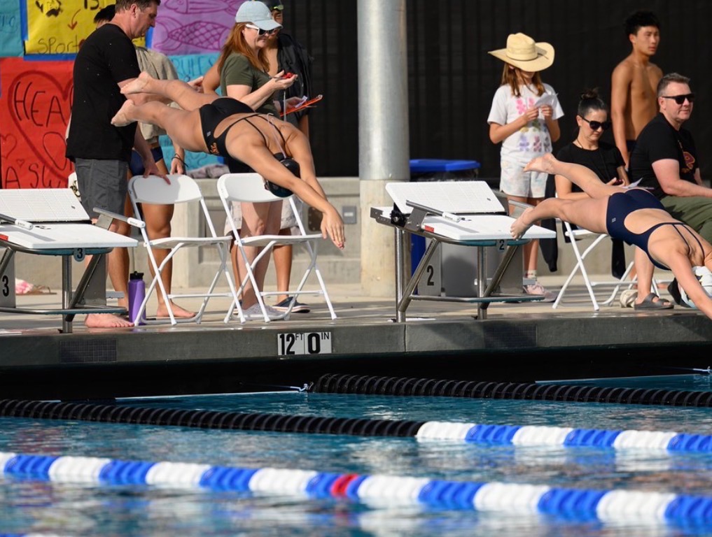 Two competing swimmers dive into the pool at the school's first home meet on campus. The pool, part of the SDUHSD Aquatic Center, opened on Jan. 27. Photo courtesy of Albert Cho and Evan Ye. 