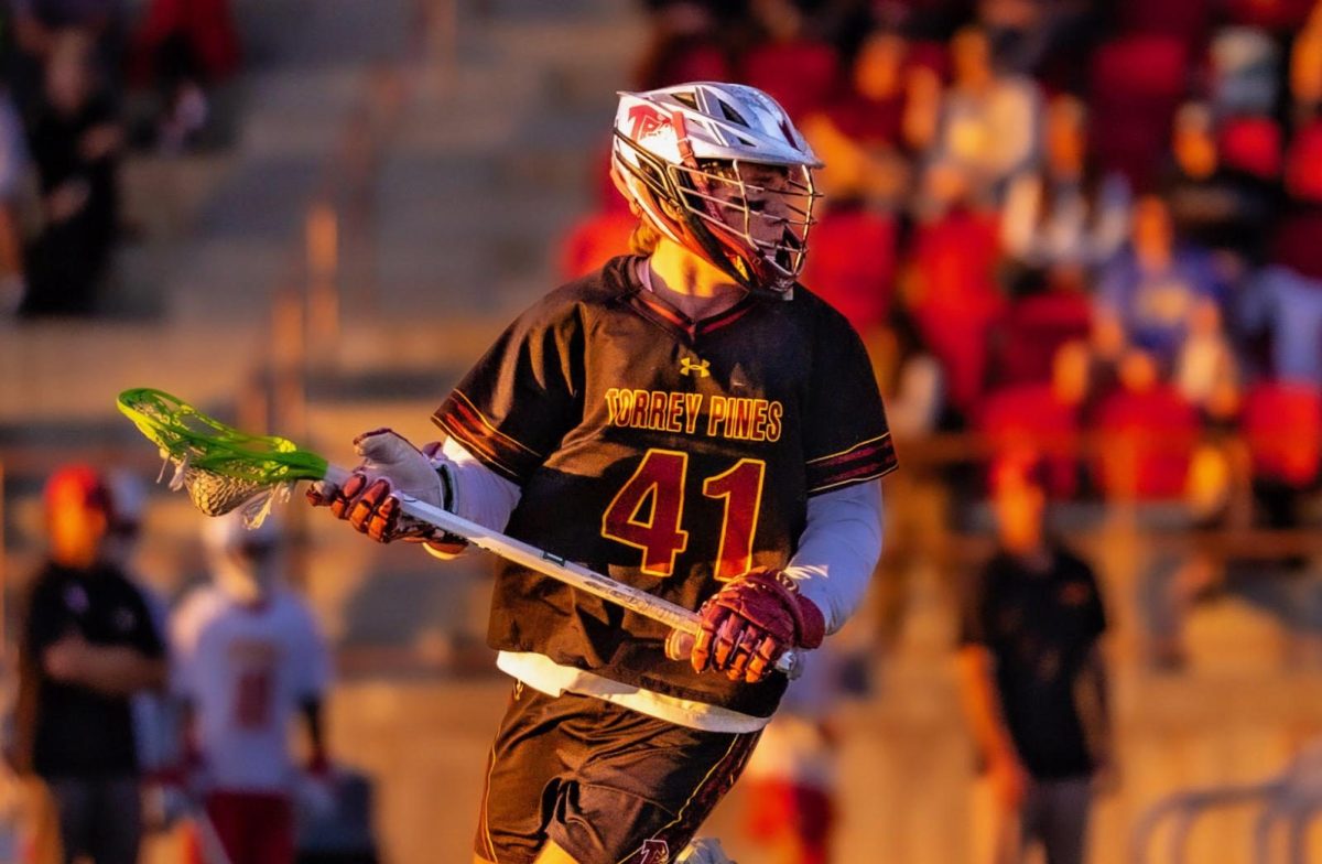 Ross Jacobsen (12) runs with a lacrosse stick in hand. Jacobsen has been a part of the sport for 12 years. Photo courtesy of Ross Jacobsen.