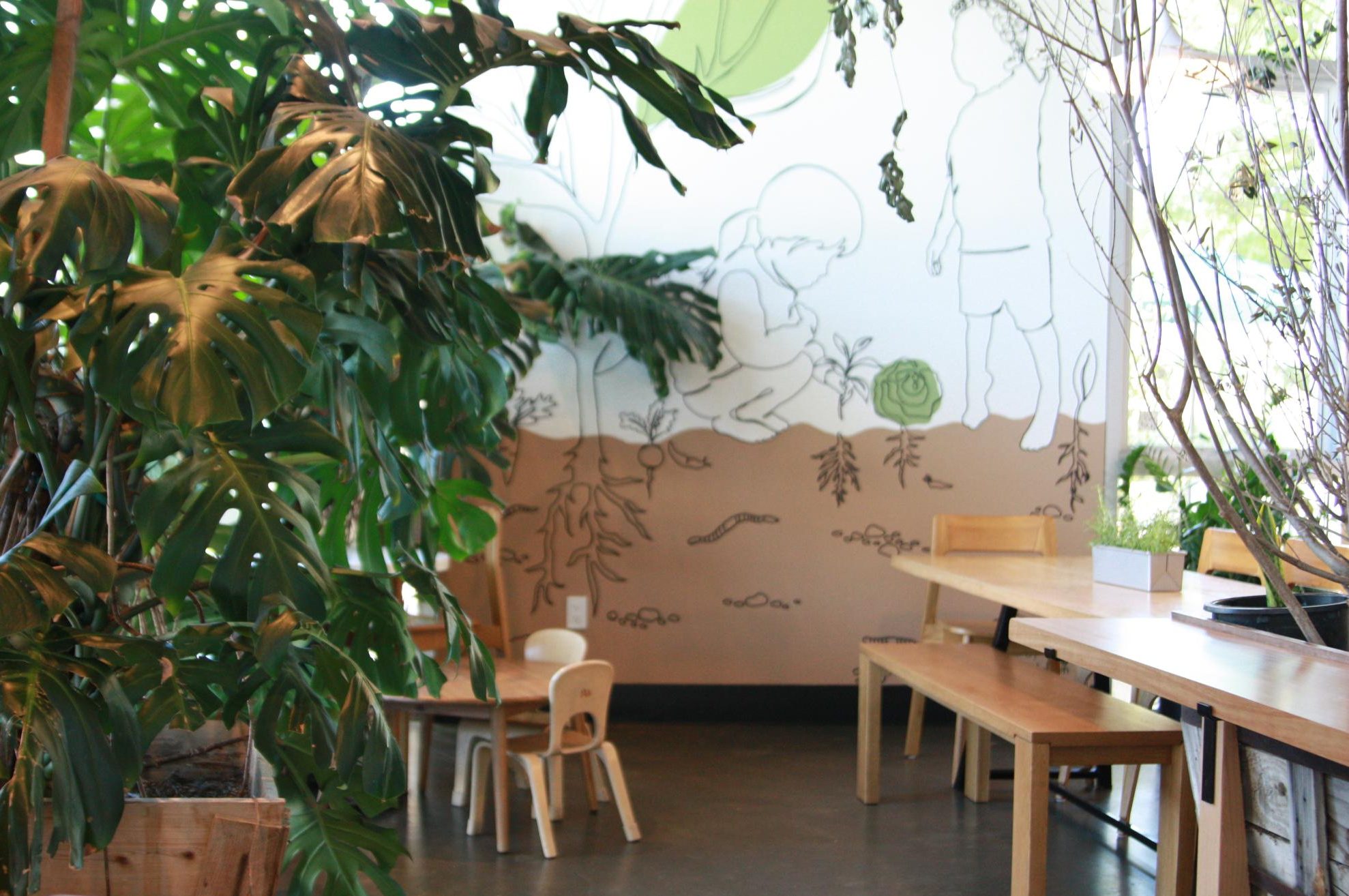 Dot Cafe offers seating for children, or smaller tables, besides regular ones. The indoor plants — leafless branches and open-palmed, Ficus elastica — were decorated throughout the cafe in partnership with Terra Bella Nursery.
