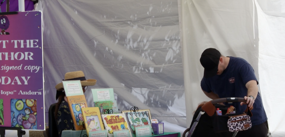 Vendors welcome patrons to their book shop at the Mission Valley Farmers Market. This was one of many vendors at the market. Photo courtesy of Warren Loftsgard.