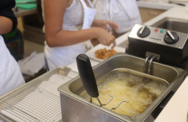 Students plate their dish while watching potatoes fry. Culinary Arts 2 was focusing on Spanish dishes, they made Spanish tortillas and patatas bravas. 