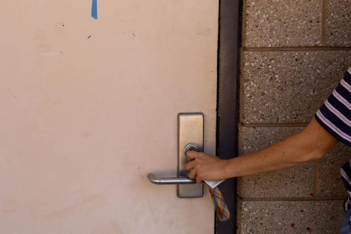 A teacher locks her classroom for safety precautions. The school began an active lockdown during second period at 10:45 a.m.