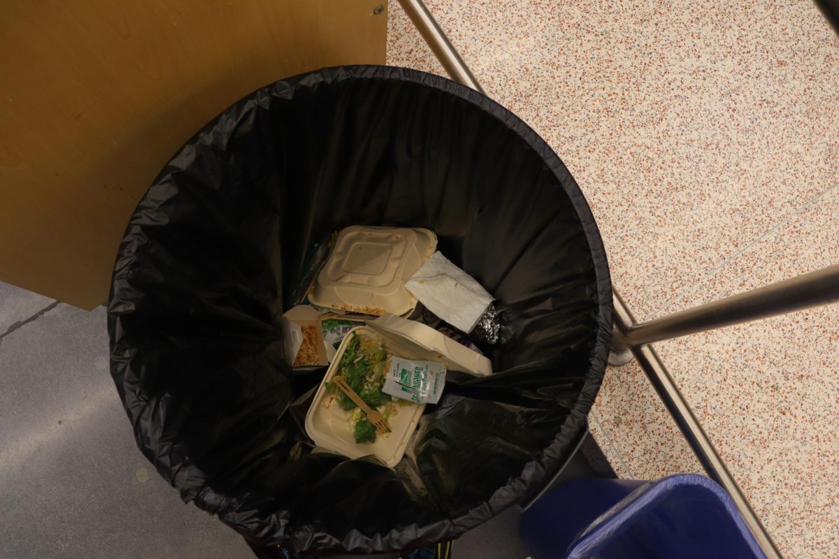 School lunches sit in the trash. Students rushed to get their food but did not finish it.
