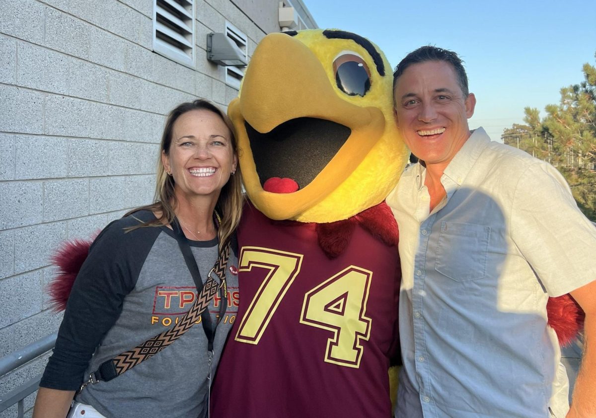 Traci Acers and Trevor Acers pose besides the Falcon mascot. Acers has been the TPHS Foundation President from 2023-26. Photo courtesy of Traci Acers.