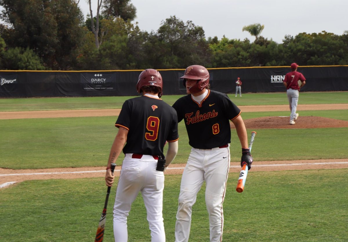 Camden Nishnick (11) celebrates with his teammate after scoring a run. He won Athlete of the Month for April.