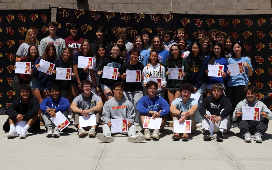 Athletic commits pose for a photo, certificates in hand. The Associated Student Body held the second annual athletic commitment ceremony in the Performing Arts Center quad on May 1.