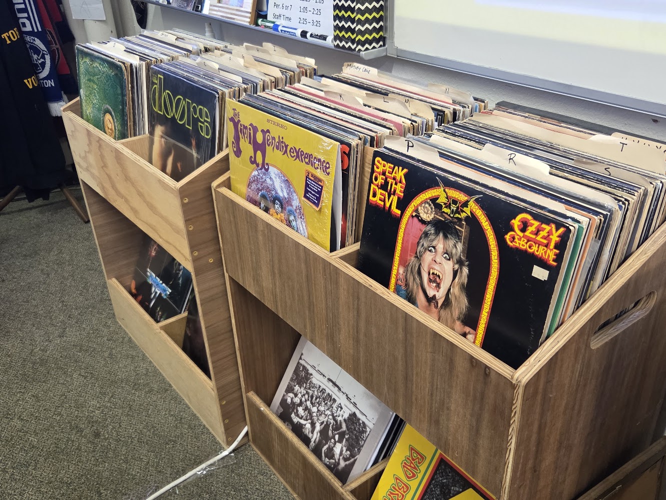 Austin Wade's shelves line with vinyl records including Ozzy Osbourne's "Speak of the Devil" and The Jimi Hendrix Experience's "Are You Experienced." Wade integrated music in his Social and Political History of Rock and Roll class by playing through vinyl albums in class.
